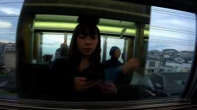 Prompt: Reflections in the window of a train traveling through the Tokyo suburbs.