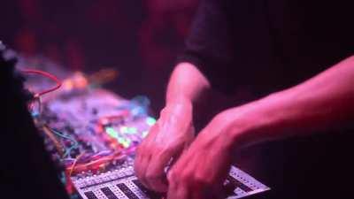 Techno artist fixes malfunctioning gear without stopping the show