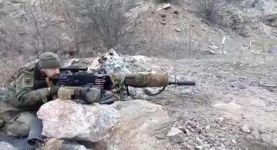 A PM M1910/30 Maxim fitted with a stock, optic, and suppressor in Ukraine