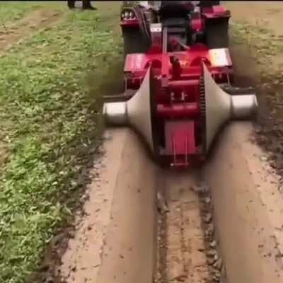 🚜 A construction machine that opens a smooth canal in the field.
