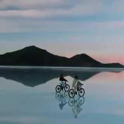 This video was produced in (Salar de Uyuni) in Bolivia, the place where heaven and earth are said to meet. It turns out that the salar (a natural reservoir of open salt) remains completely dry on most days of the year, but in the rainy season that comes w