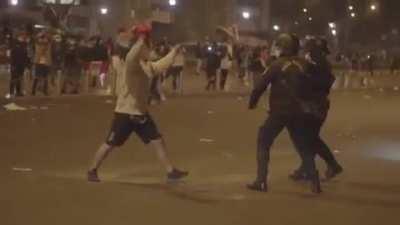 Beautiful punch from guy fighting the oppressive police of the Peruvian dictator