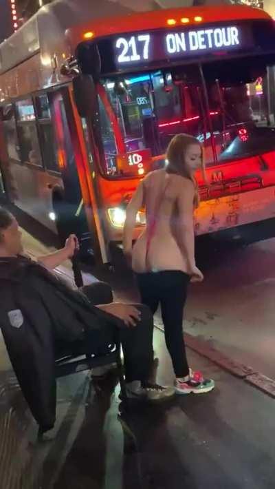 Redhead gives a lap dance to a stranger at the bus stop