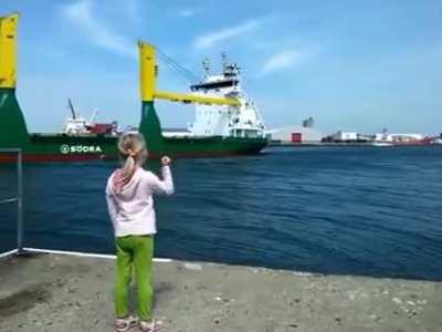 Girl honks at ship