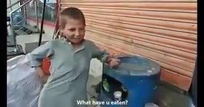 This poor kid from Pakistan who makes his living by selling plastic which he collects from street buys milk for a stray cat