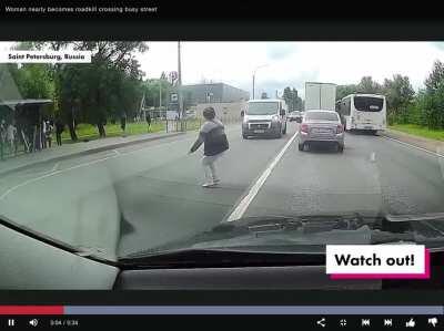 Woman almost loses at real life game of frogger.