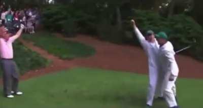 A caddy hits a hole in one infront of Golf Legends