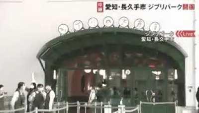 Hayao Miyazaki casually walks by during a news report about newly opened Ghibli park