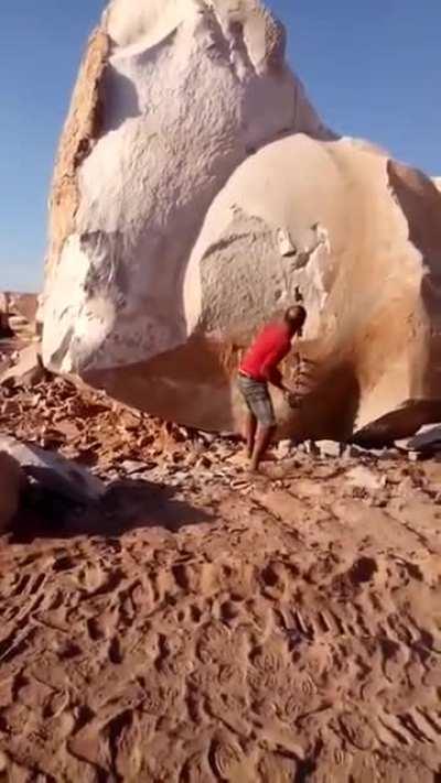 Dude splits apart big rock