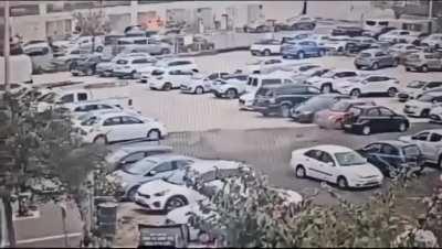 The Husk of an intercepted rocket falls in a Tel Aviv parking lot