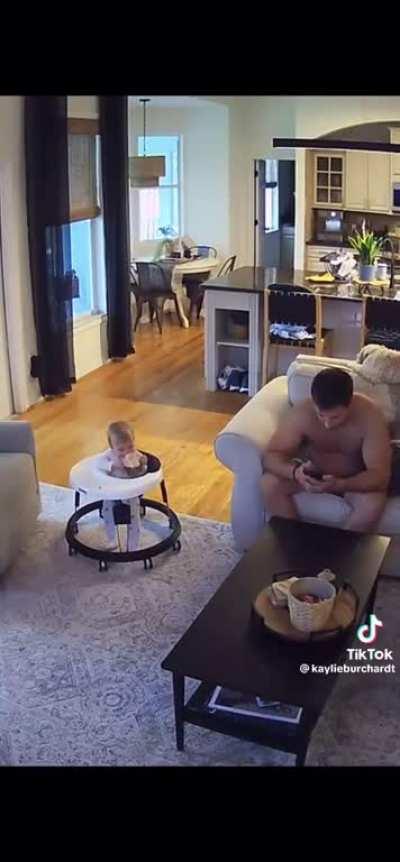 Infant daughter steals a drink in plain sight from her distracted dad