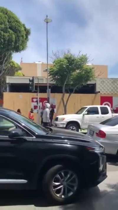 Different POV of man w/ hockey stick being jumped after defending a woman who was being robbed by looters.