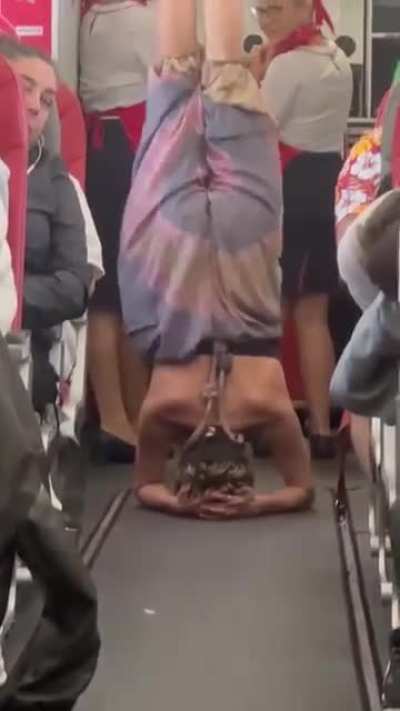 woman doing yoga on a flight from ibiza to manchester