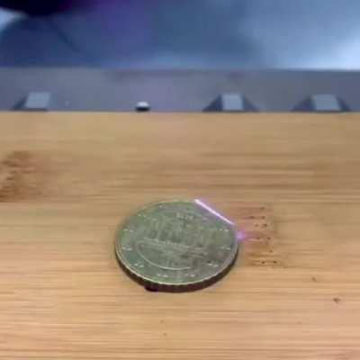 Laser ablation to remove rust from a coin