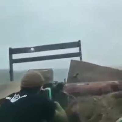 Chechen/Ukrainian fighters firing a PKM at Russian positions while listening to hard bass