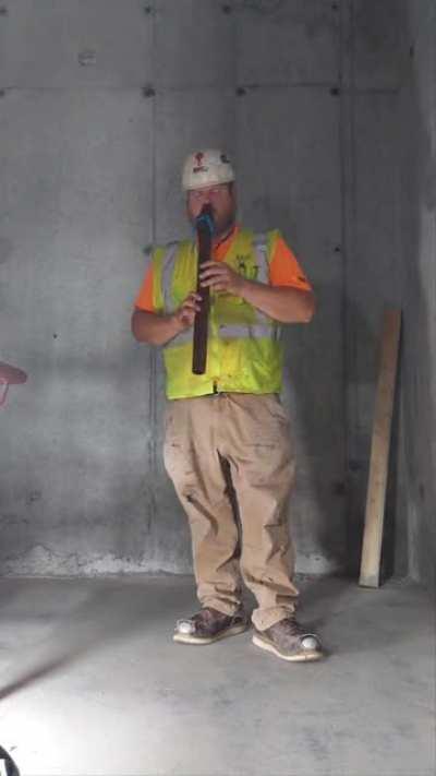 Ironworker plays melodious tune in a stairwell