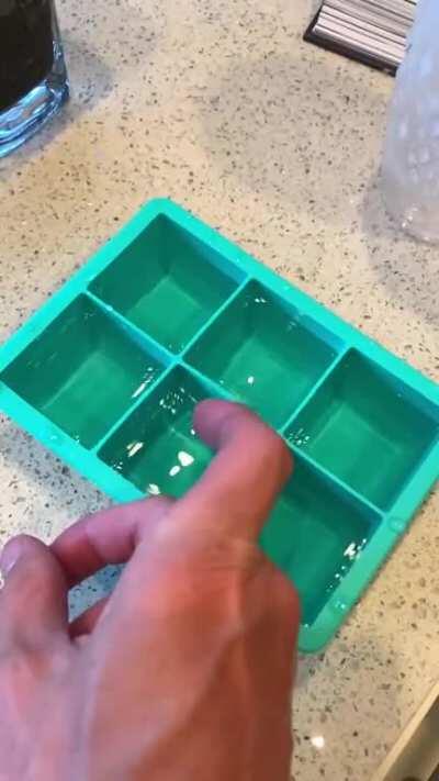 Ice cube tray slow motion ripples