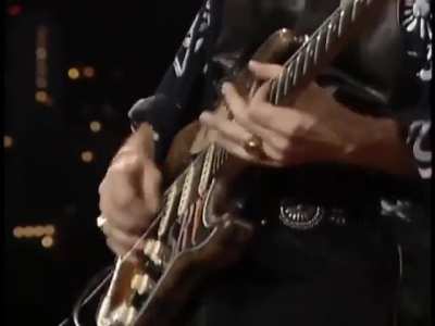 Stevie Ray Vaughan breaks a guitar string while performing and effortlessly swaps guitars mid song