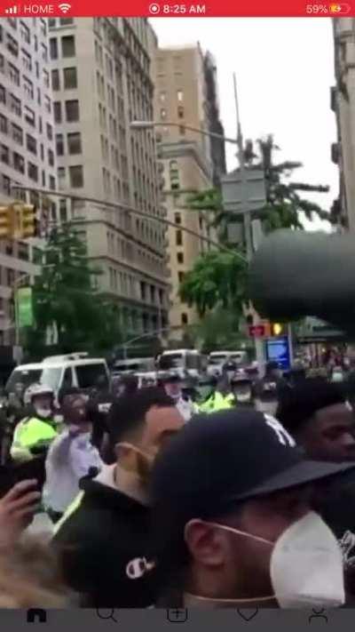 Man throwing garbage bin on police officers going by