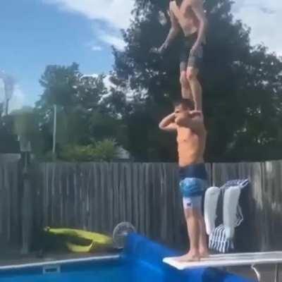 Diving from friends shoulders on the diving board