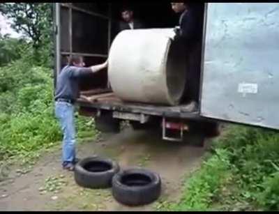 WCGW unloading a concrete pipe with tires