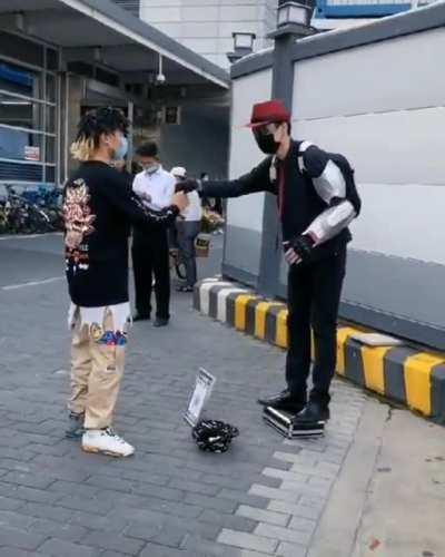 The greeting between the robot street performer and another with the similar skill set