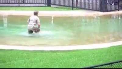 Robert Irwin, wearing his Dads shoes, Asking Mum if he can get in the water...