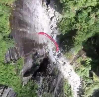 These freaks parachute glide through a massive mountain ravine while doing 360 deep dives... just watching this puts hair on my chest ( Credit: Espenfadnes )