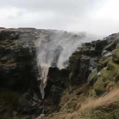 Heavy wind change the flow of this waterfalls direction in the opposite direction