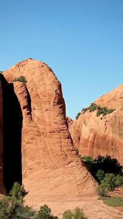 Mountain biker Kilian Bron riding down an ultra steep slab in Moab