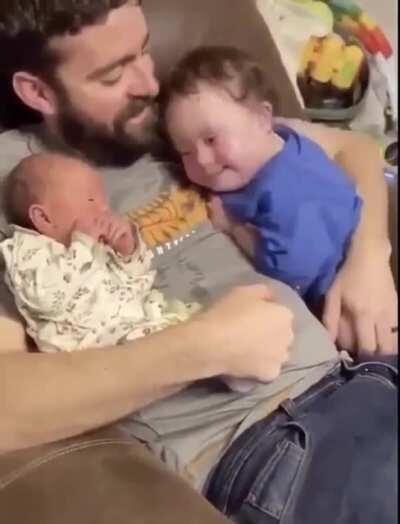 This boy meeting his newborn sister for the first time