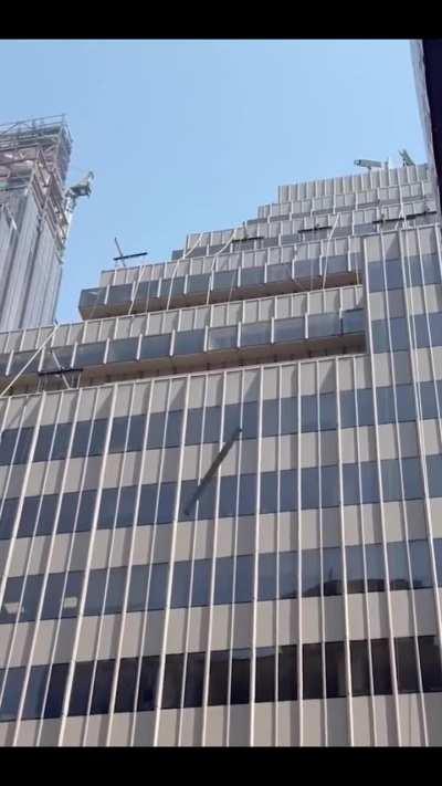 Someone throwing furniture from the top of a midtown Manhattan building onto the busy street.