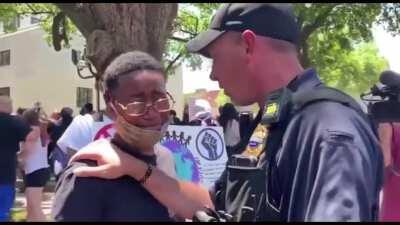 Shreveport police comforting protester