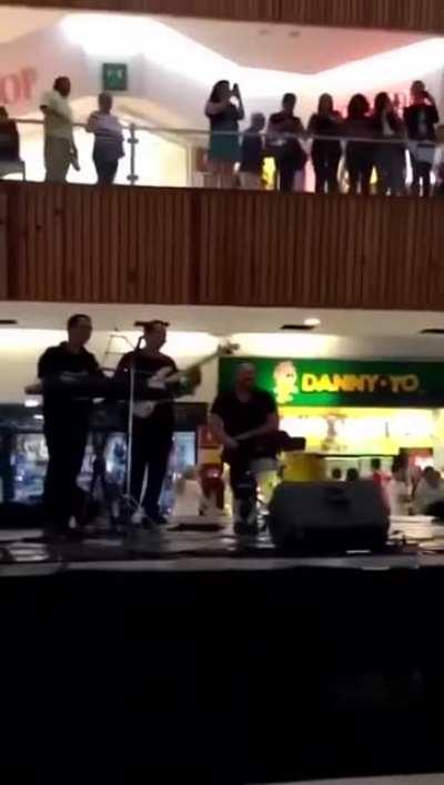 The mall started flooding so the live band starts to perform the Titanic song