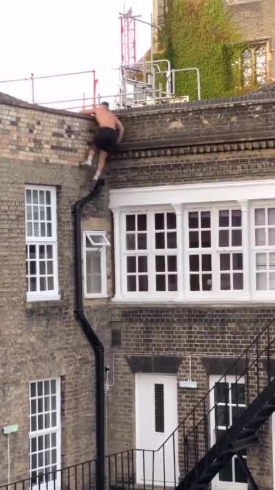 A guy climbs a building effortlessly