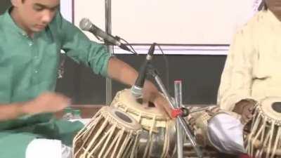 Young tabla(Indian percussion instrument) player Ishaan Ghosh showing how complex Indian percussion can get. Discipline and hardwork shining through. 16 beat cycle called Teentaal.