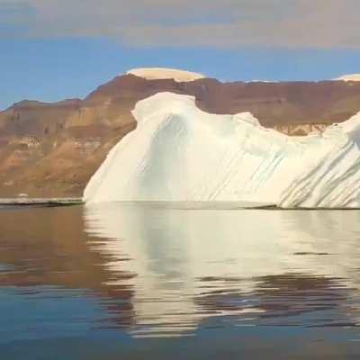 An iceberg rolling over