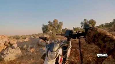 Syrian rebel shooting a machine gun mounted on a motorcycle at SAA positions yesterday in Idlib, Syria. 8/18/2021.