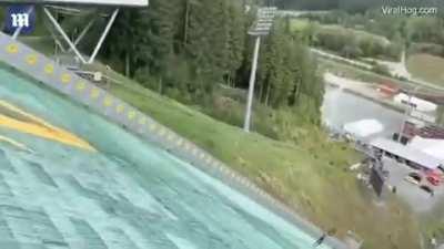 Mountain biker tries to jump off dry ski slope