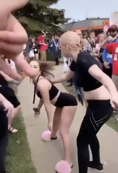 Woman twerks at group of people who are protesting anime.