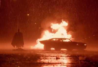 Batman walking from the burning wreckage BTS