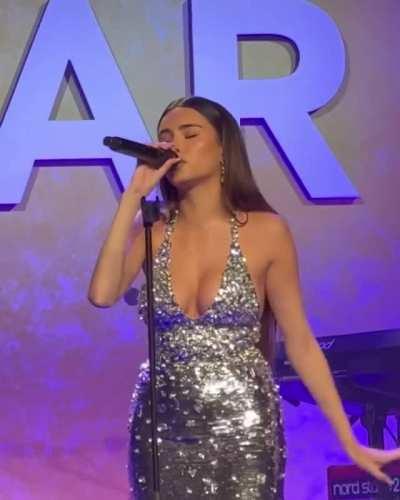 Showing off her cleavage while performing