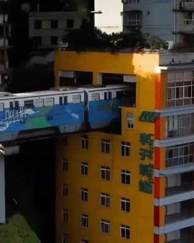 A train running through residential apartments in China