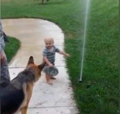 Baby showing his puppy water is not sth to be afraid of