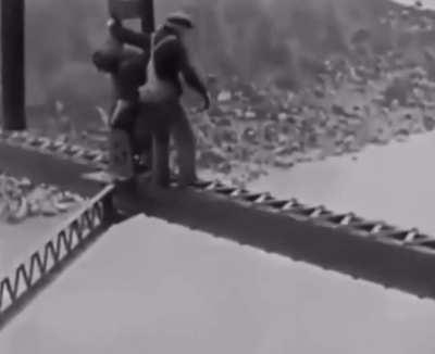 Bridge construction in the 1920s with no safety harness.