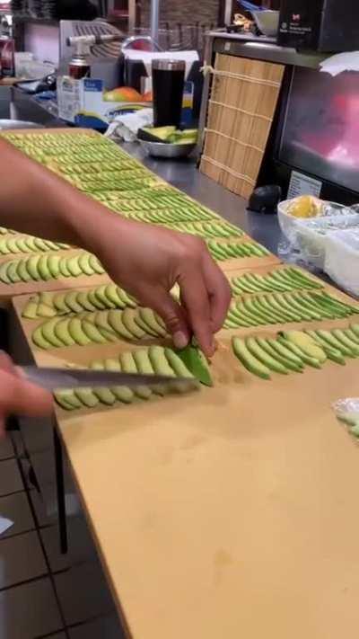 Perfectly slicing avocado pieces.