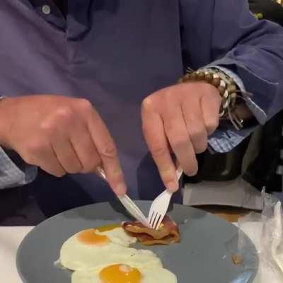 Close-up footage of a orangutan using cutlery