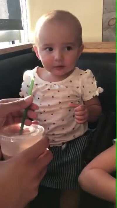 Baby trying chocolate milk for the first time