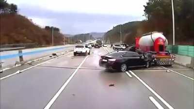 Man stands in highway to signal cars to slow down