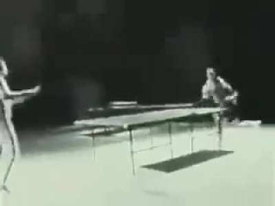 Bruce Lee playing table tennis using nunchucks